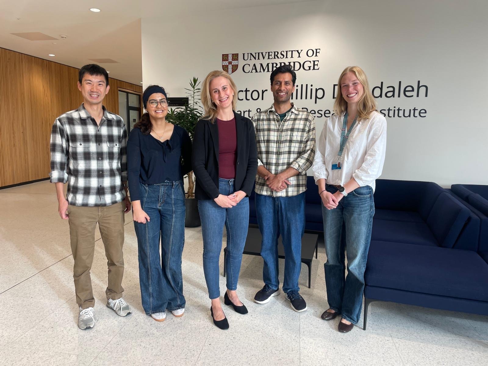 The Vujic Lab team in the atrium of the Victor Phillip Dahdaleh Heart and Lung Research Institute, University of Cambridge